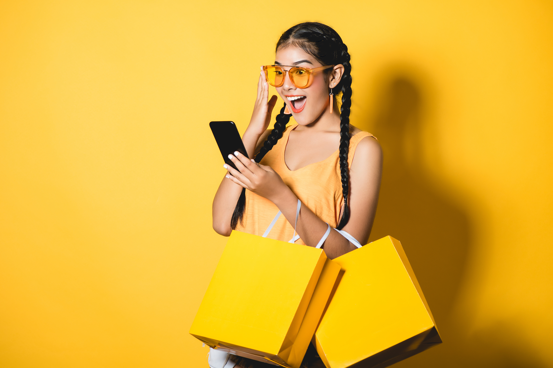 Happy smiling shopper with yellow bags
