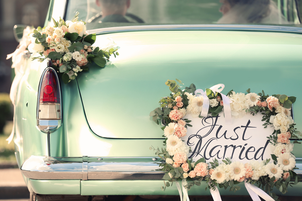 Turquoise car with just married sign on back